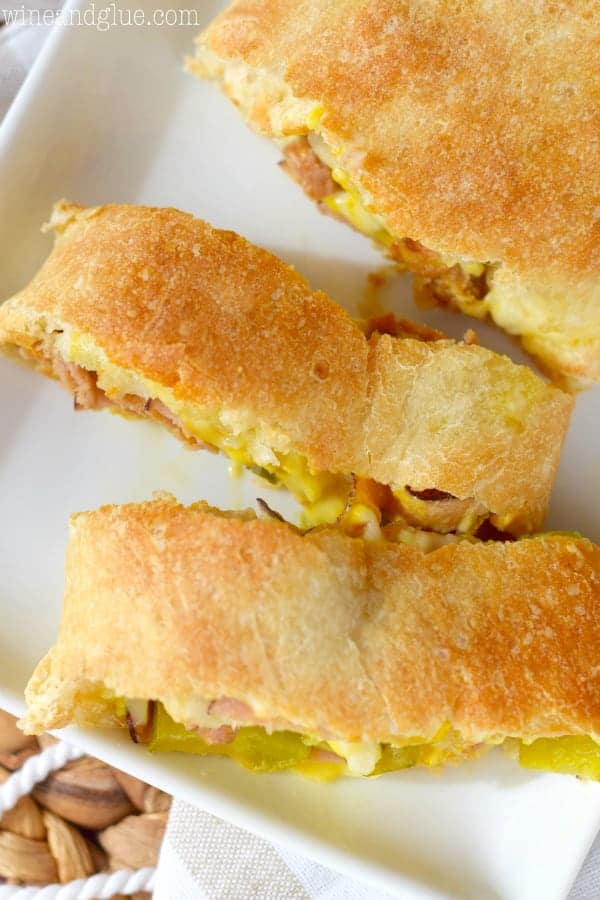 An overhead photo of rectangular pieces of the Cuban Stromboli showing some of the mustard and cheese oozing out. 