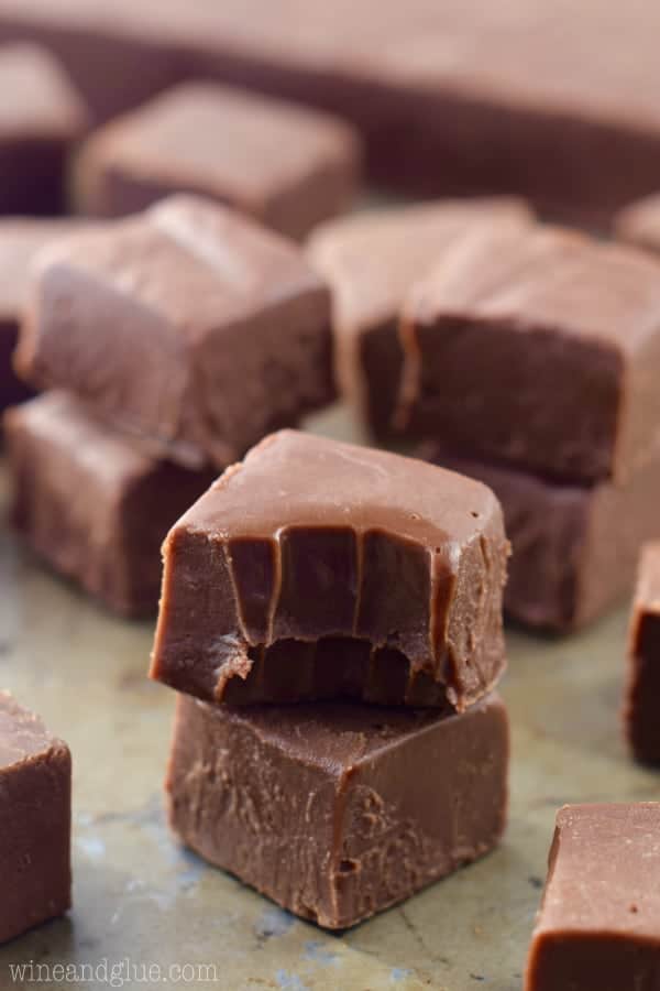 A little cube of Nutella Fudge has a little bit into it showing the creamy center. 