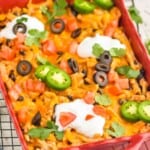 side view of an easy taco casserole in a red baking dish - 7