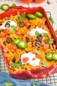 side view of an easy taco casserole in a red baking dish