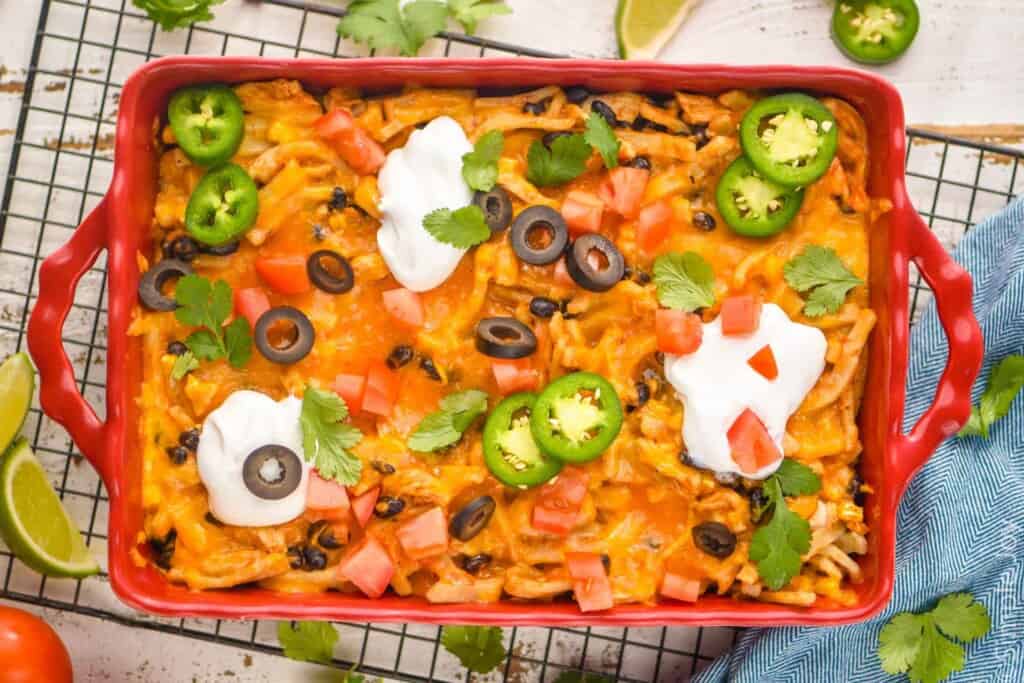 overhead of a taco casserole in a baking dish garnished with taco toppings