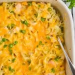 overhead view of a turkey noodle casserole in a ceramic baking dish with a spoon going in - 13