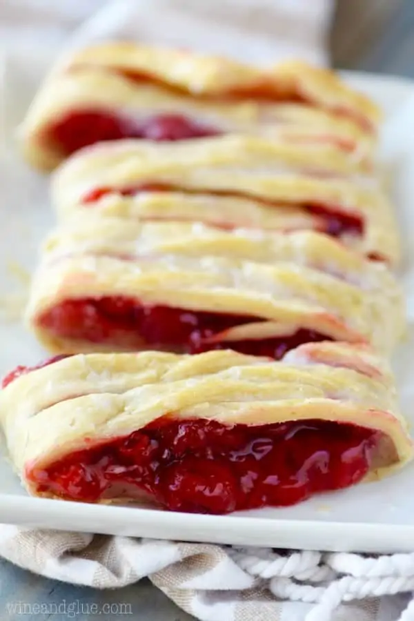 The Cherry Almond Braid has a flaky golden pie crust with a gooey cherry middle that is oozing out. 