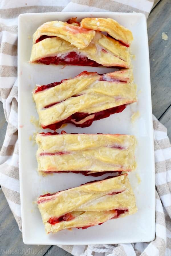 An overhead photo of the Cherry Almond Braid cut into rectangular pieces showing the cherry filling oozing out. 
