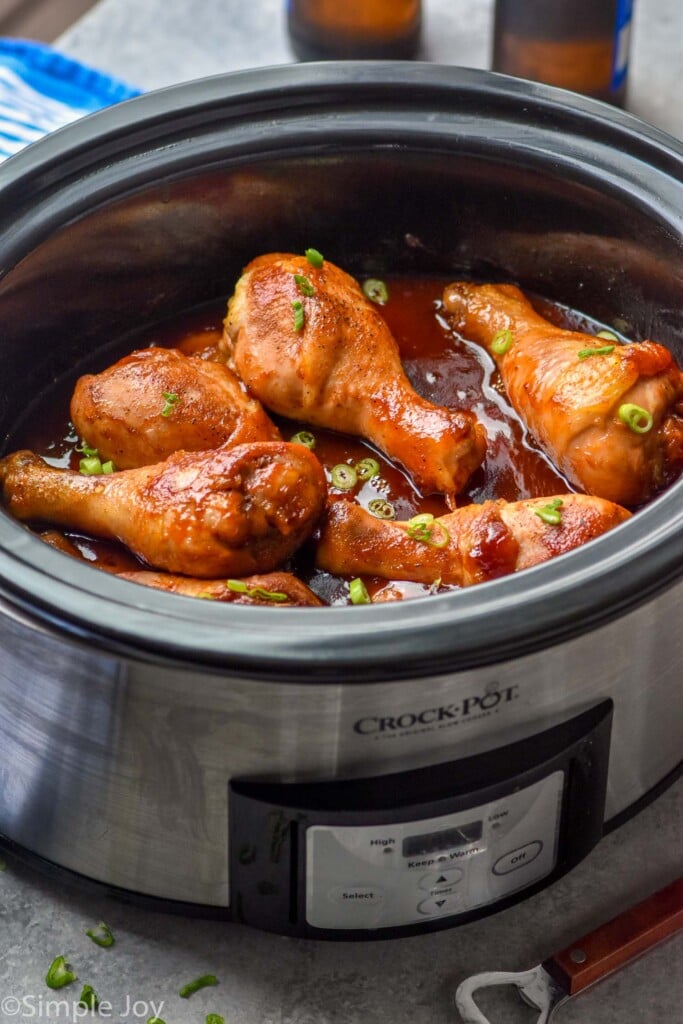 Overhead photo of Crock Pot Chicken Drumsticks recipe in a slow cooker.