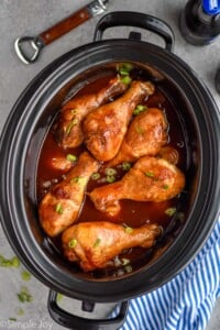 Overhead photo of Crock Pot Chicken Drumsticks recipe in a slow cooker.