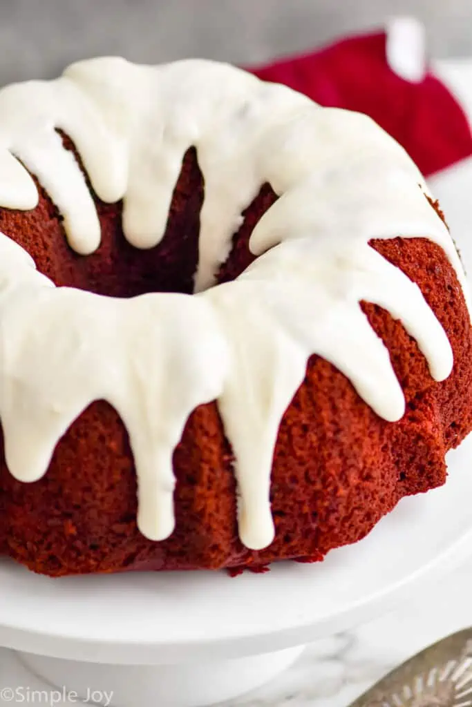 a red velvet bundt cake on a cake stand