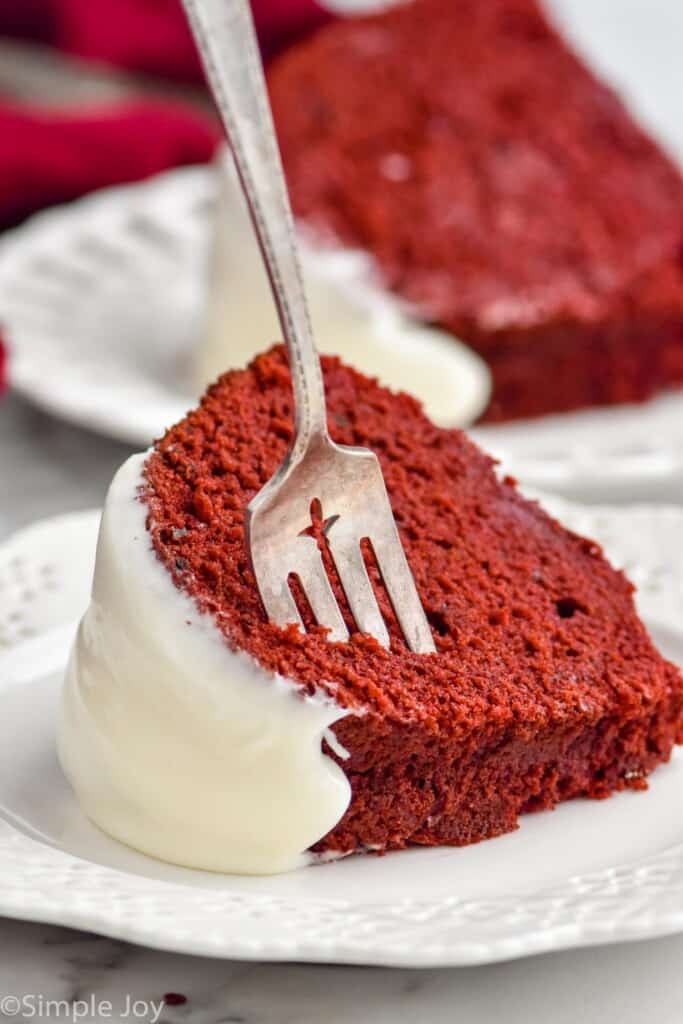 a piece of red velvet bundt cake on it's side with a fork sticking out