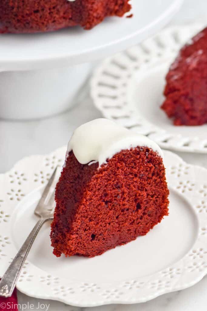 piece of red velvet cake sitting up on a white plate