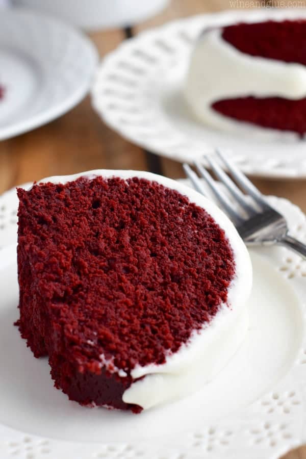 A slice of the Red Velvet Sour Cream Bundt Cake with Cream Cheese Buttermilk Frosting showing the moist and airy cake. 