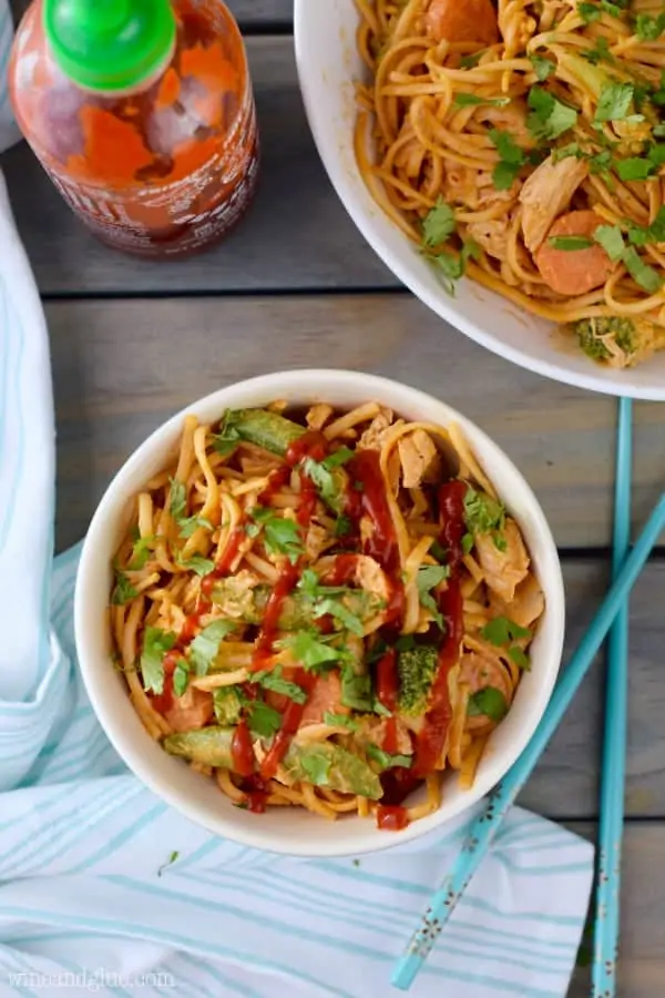 An overhead photo of the Sriracha Noodles Bowls topped with a drizzle of Sriracha and minced cilantro. 