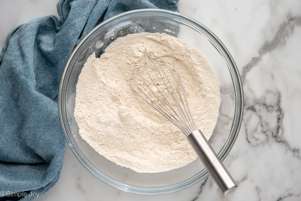 overhead of a bowl of flour with a whisk - 5
