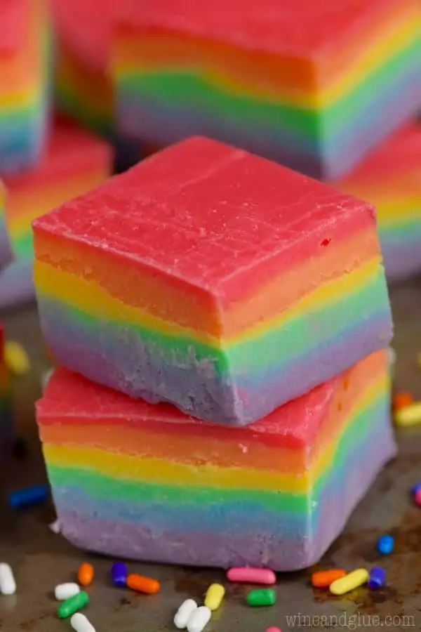 A stack of the Rainbow Fudge in cube shapes showing the distinct colors of red, orange, yellow, green, blue, and purpler (in that order). 