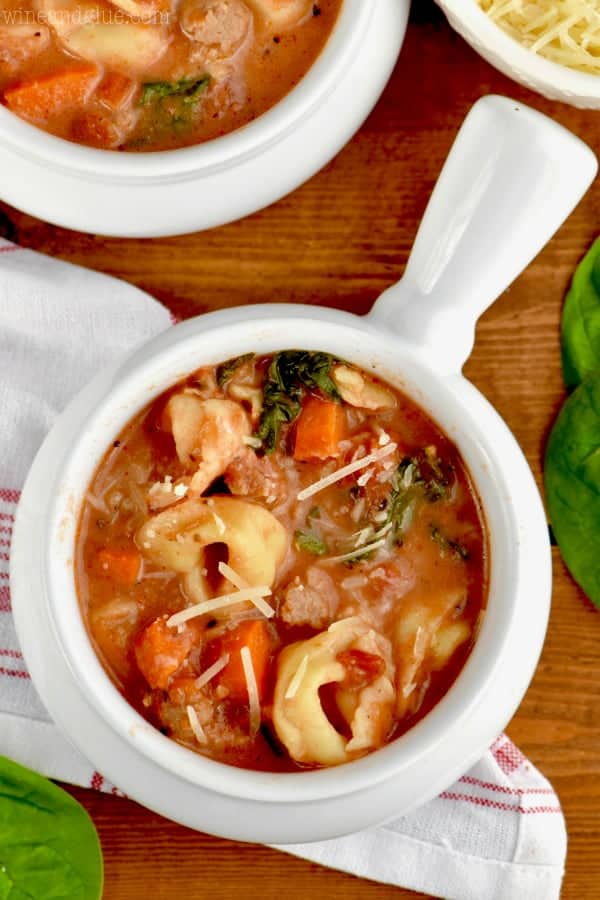 An overhead photo of the Slow Cooker Creamy Tortellini Soup topped with parmesan cheese. 