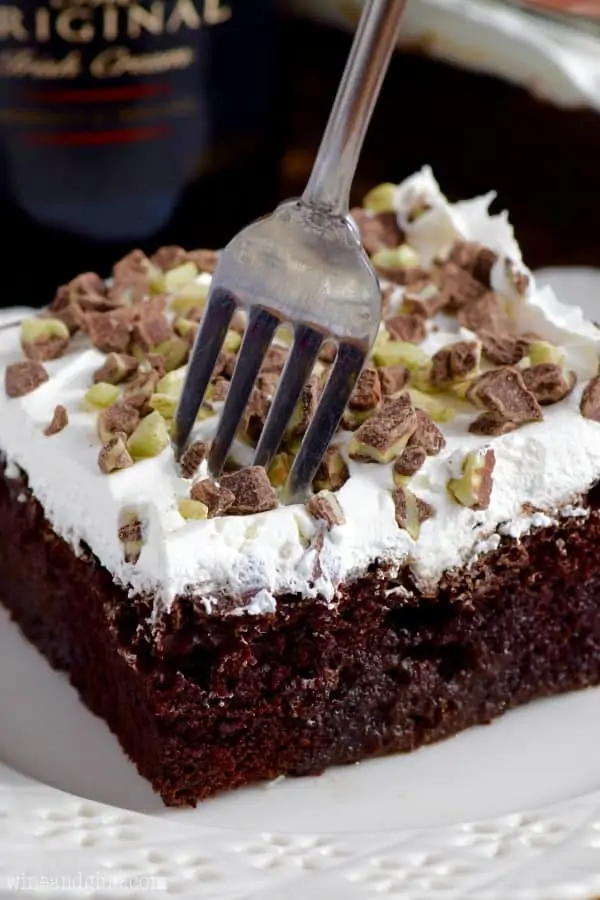 A fork digging into the fluffy cool whip layer and into the moist chocolate layer. 