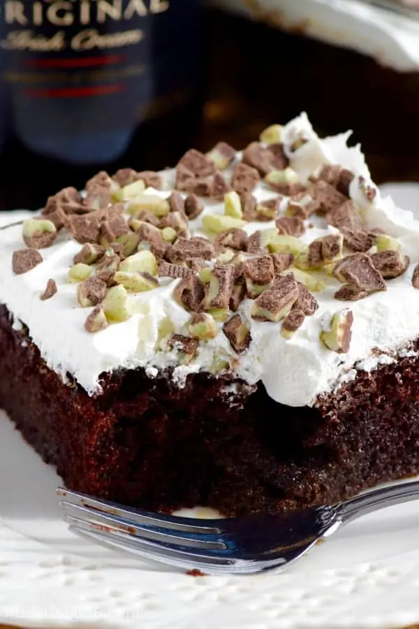 close up of a piece of baileys poke cake with a bite missing