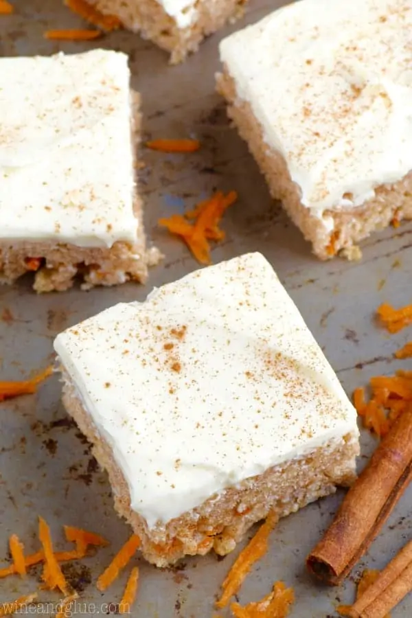 An overhead photo of the Carrot Cake Rice Krispies cut in little squares and topped with cream cheese frosting and cinnamon powder. 