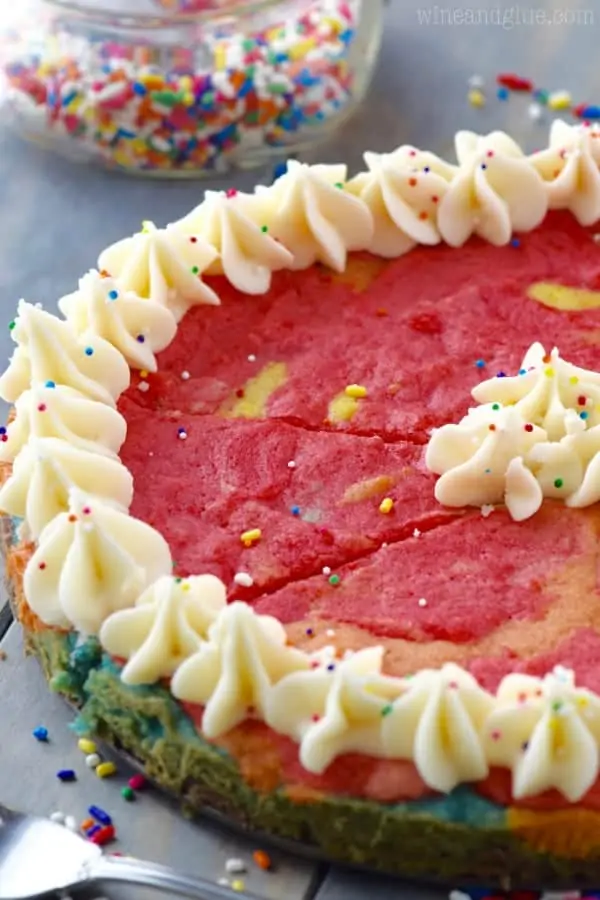 The Rainbow Sugar Cookie cake has vanilla frosting piped on the edges with a star tip. 