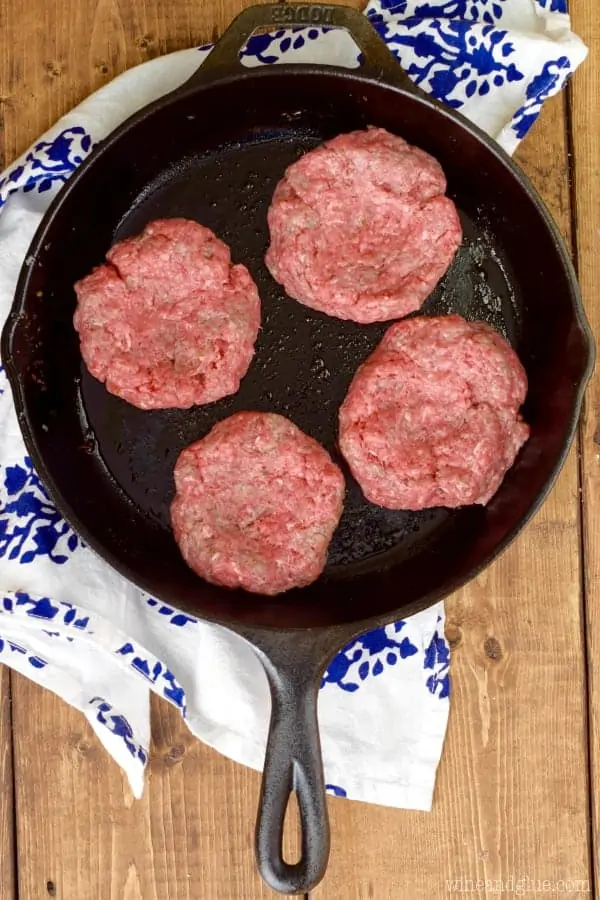 On a cast iron skillet, the Ranch Patties are flattened and being cooked. 