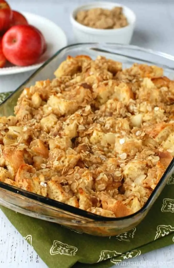 In a glass casserole, the Apple Pie Overnight Stuffed French Toast has a golden brown color. 