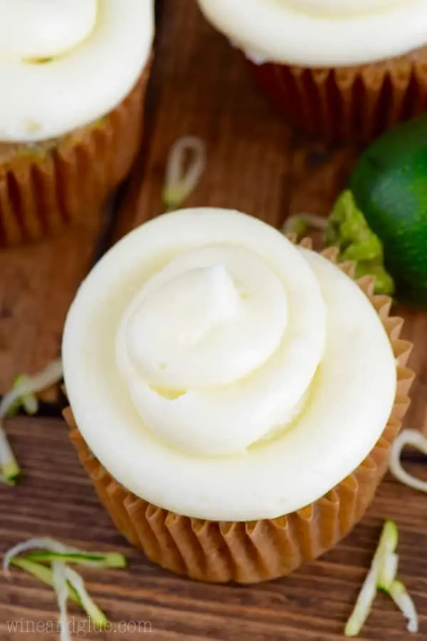 In a cupcake tin, the Zucchini Cupcake has a dark golden brown color topped with a fluffy cream cheese frosting. 