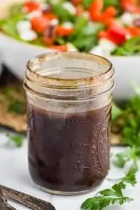 a mason jar containing balsamic dressing