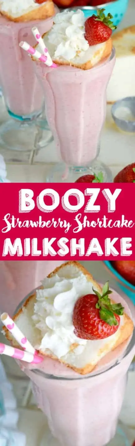 In a milkshake glass, the pink Boozy Strawberry Shortcake Milkshake is topped with a small slice of a strawberry shortcake, a sliced strawberry, and whipped cream.