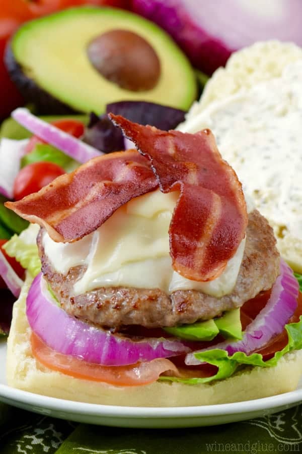 Without top bun, the California Club Burger has turkey bacon, turkey patty, melted cheese, red onion, tomatoes, and lettuce. 