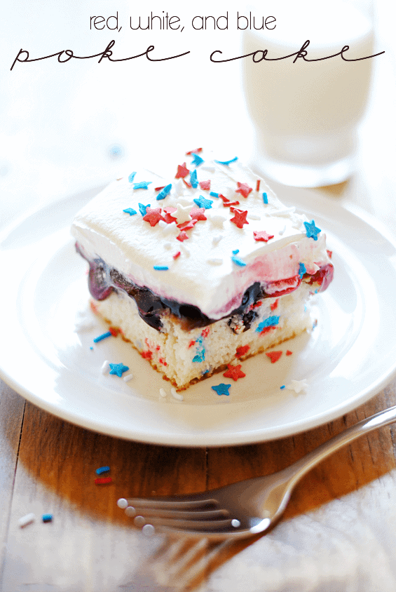 A slice of the Red White and Blue Poke Cake has a moist cake interior and topped with blueberry syrup and white fluffy frosting. 