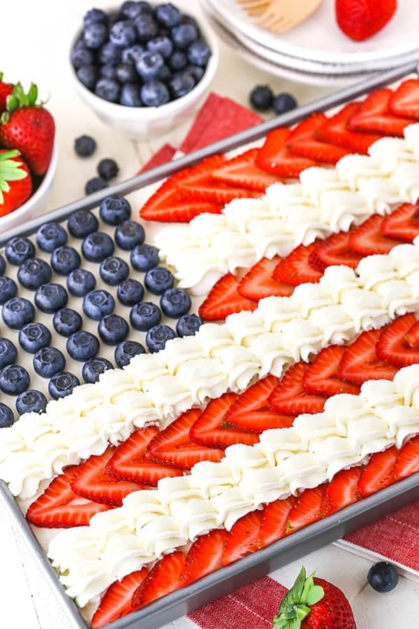 On a baking sheet, the Angel Food Flag Cake has blueberries in the blue section of the flag, and strawberries and white frosting makes up the stripes. 