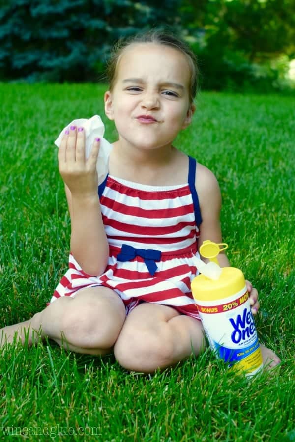 A little girl wiping her hands with the Wet Ones' wipes. 