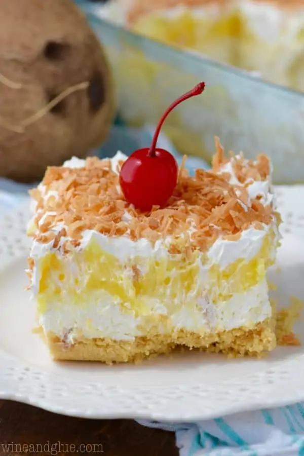 The No Bake Pina Colada Lush has a golden Oreo crust with a fluffy cream and chunks of pineapples for a middle and topped with roasted coconuts. 