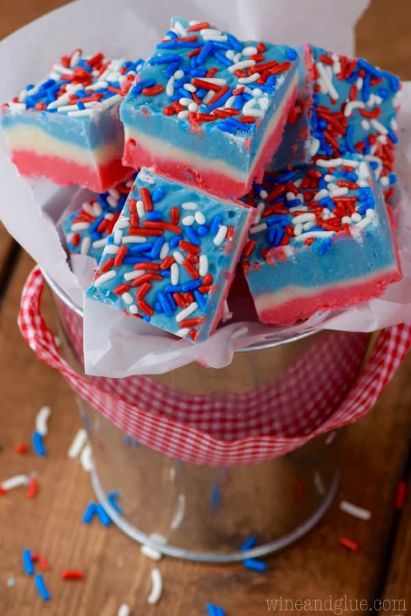 In a metal bucket, he Red, White, and Blue Fudg has the distinct colored layers and topped with red, white, and blue sprinkles. 