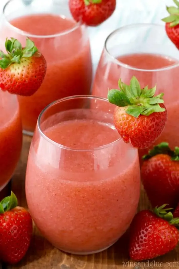 In glasses, the Strawberry Daiquiri Sangria have a frosted red coloring and on the rim is a strawberry. 