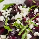 white bowl filled with easy beet salad of roasted beets, feta cheese, and fresh basil