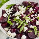 white bowl filled with easy beet salad of roasted beets, feta cheese, and fresh basil - 9