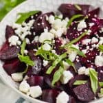 white bowl filled with easy beet salad of roasted beets, feta cheese, and fresh basil
