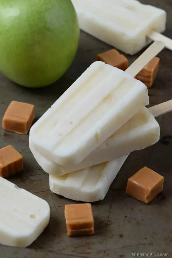 The Lighter Caramel Apple Pipe Pops have a off-white color on wooden sticks. 