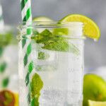 a mason jar with a low calorie mojito in it garnished with a lime wedge