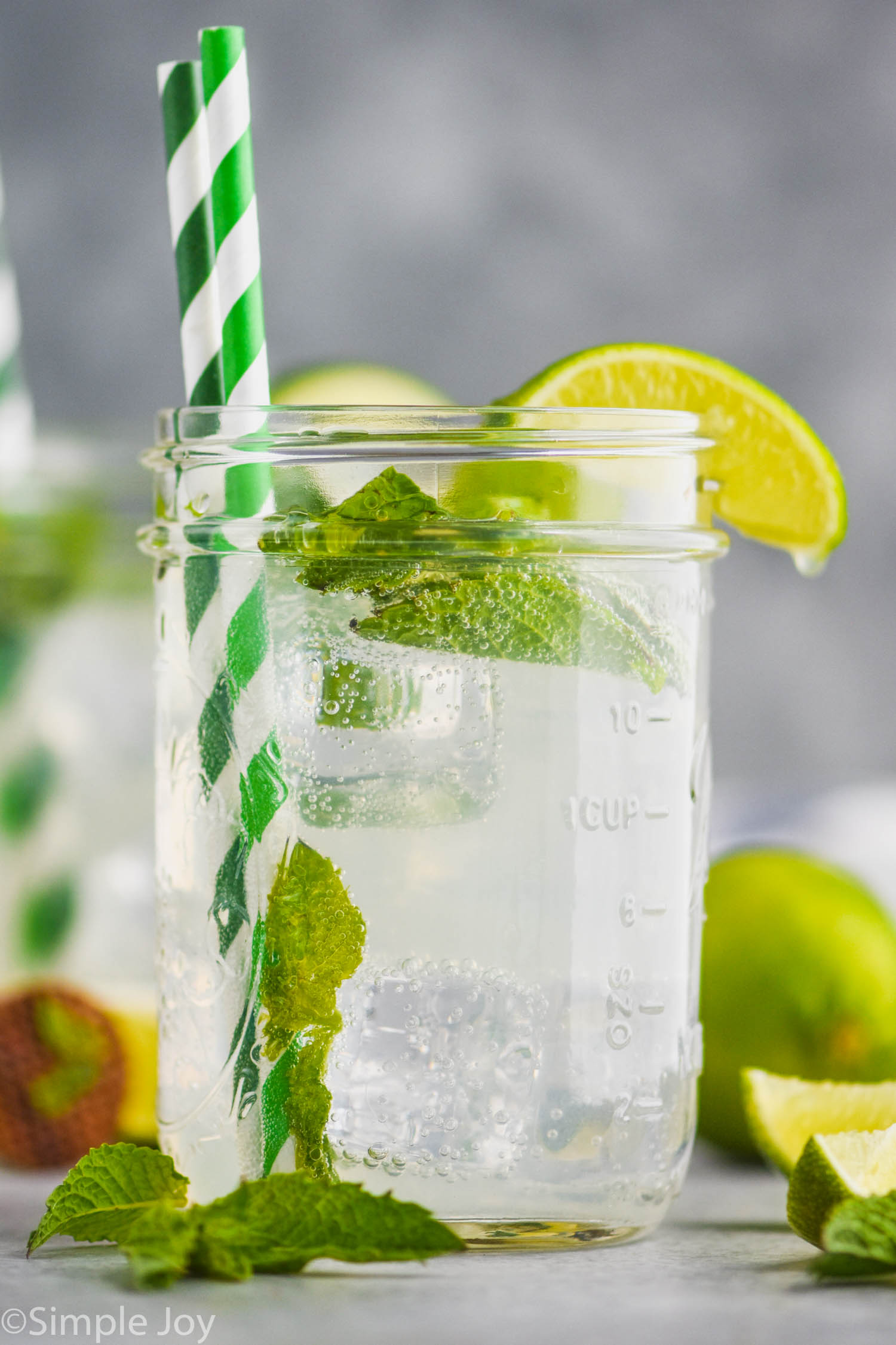 a mason jar with a low calorie mojito in it garnished with a lime wedge