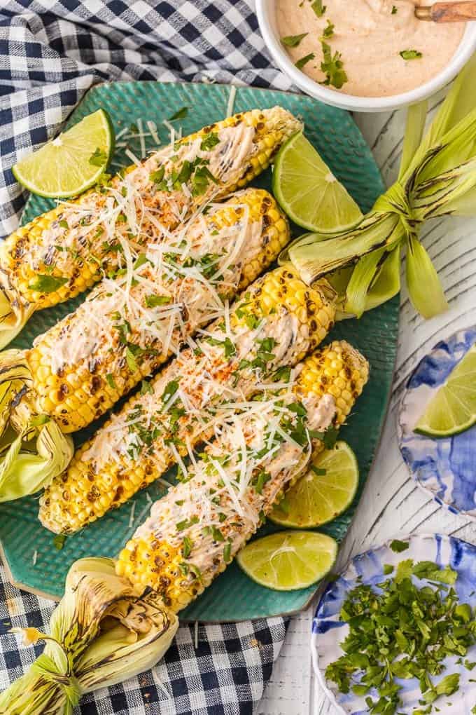 The Grilled Mexican Corn has beautiful charcoal specks topped with Sour Cream Taco seasoning sauce, parmesan, and cilantro. 
