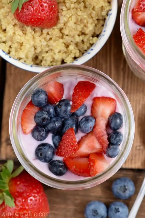 An overhead photo of the top of the Quinoa Berry Parfait showing that the Mixed Berry Yogurt on top and topped with chopped strawberries and blueberries. 