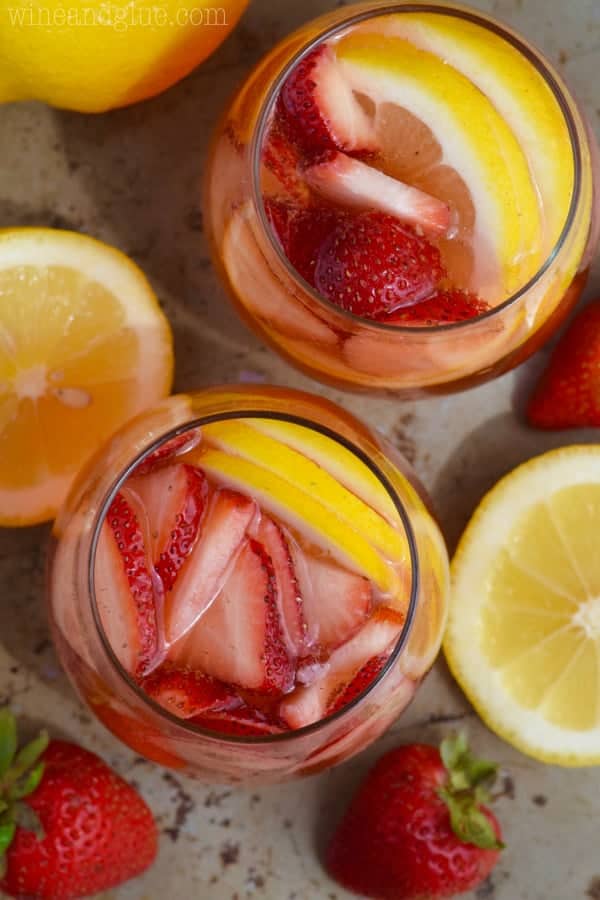 Overhead photo of two Strawberry Lemonade Spritzers with sliced strawberries and lemons. 