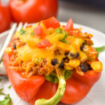 a taco stuffed pepper on a plate topped with chopped tomatoes and cilantro - 21