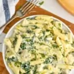 overhead view of a plate of spinach artichoke chicken pasta recipe