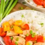 pinterest graphic showing a shallow bowl holding sweet and sour chicken and rice, garnished with scallions