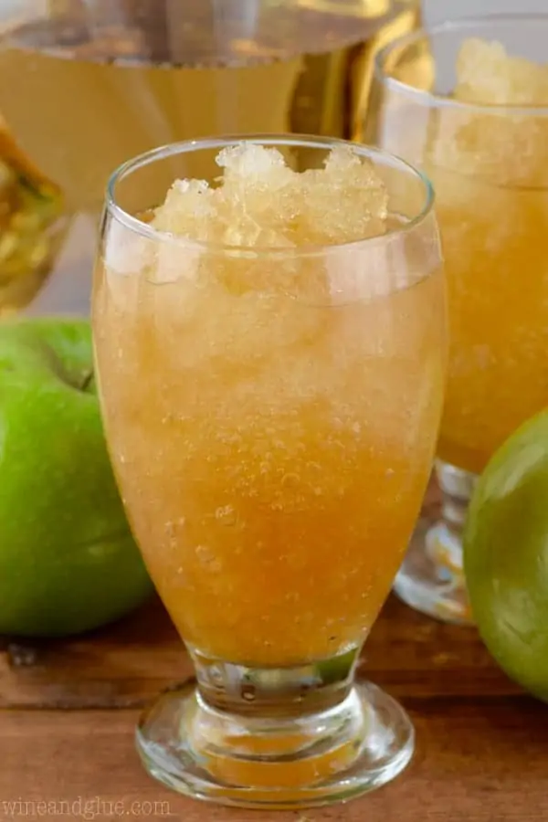 In a glass, the Apple Brandy Slush has a slushy like consistency and has a apple juice coloring. 