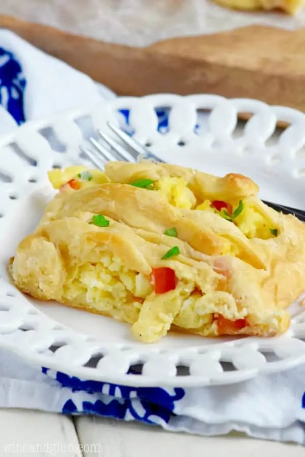 On a white plate, a slice of the Breakfast Braid shows the fluffy eggs with diced red peppers in the middle. 