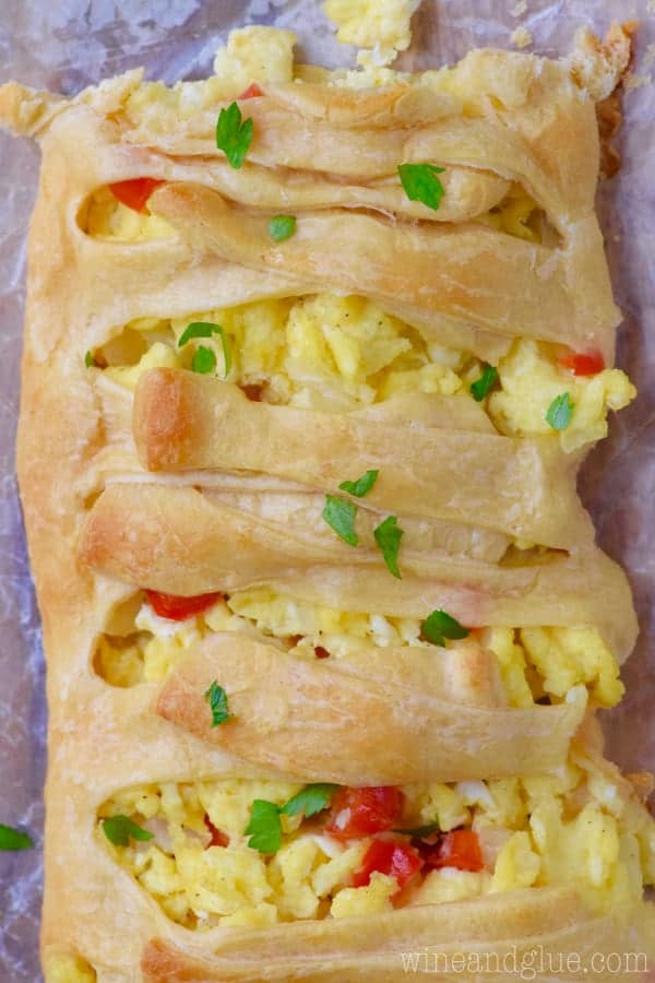 An overhead photo of the Breakfast Braid showing the fluffy cheesy eggs with red diced peppers. 