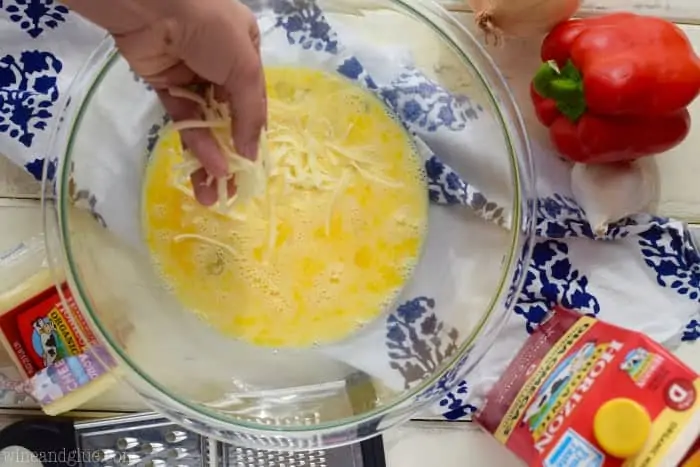 The Horizon Cheese is shredded and sprinkled into the whisked eggs. 